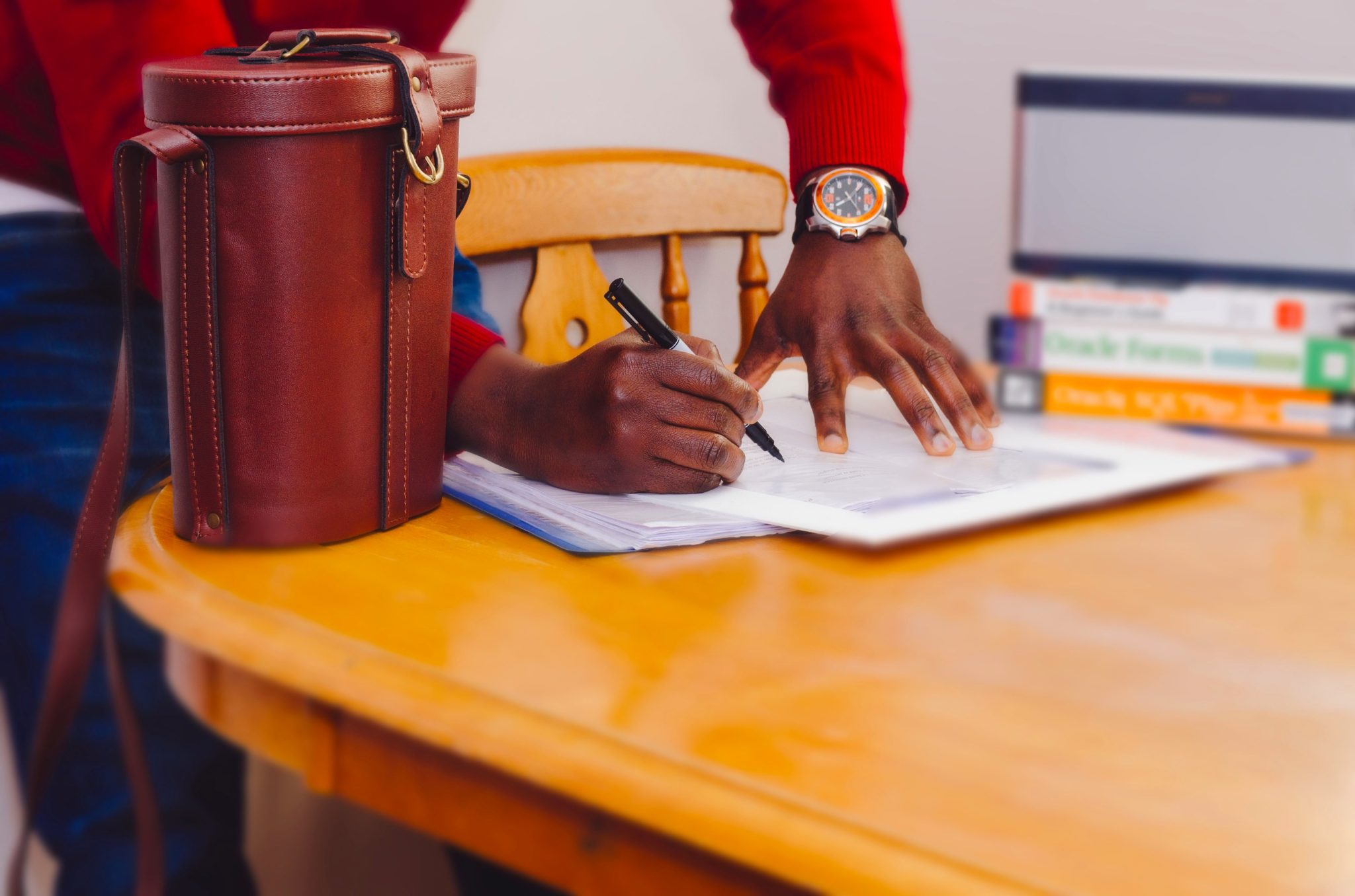 man signing a document and closing a deal