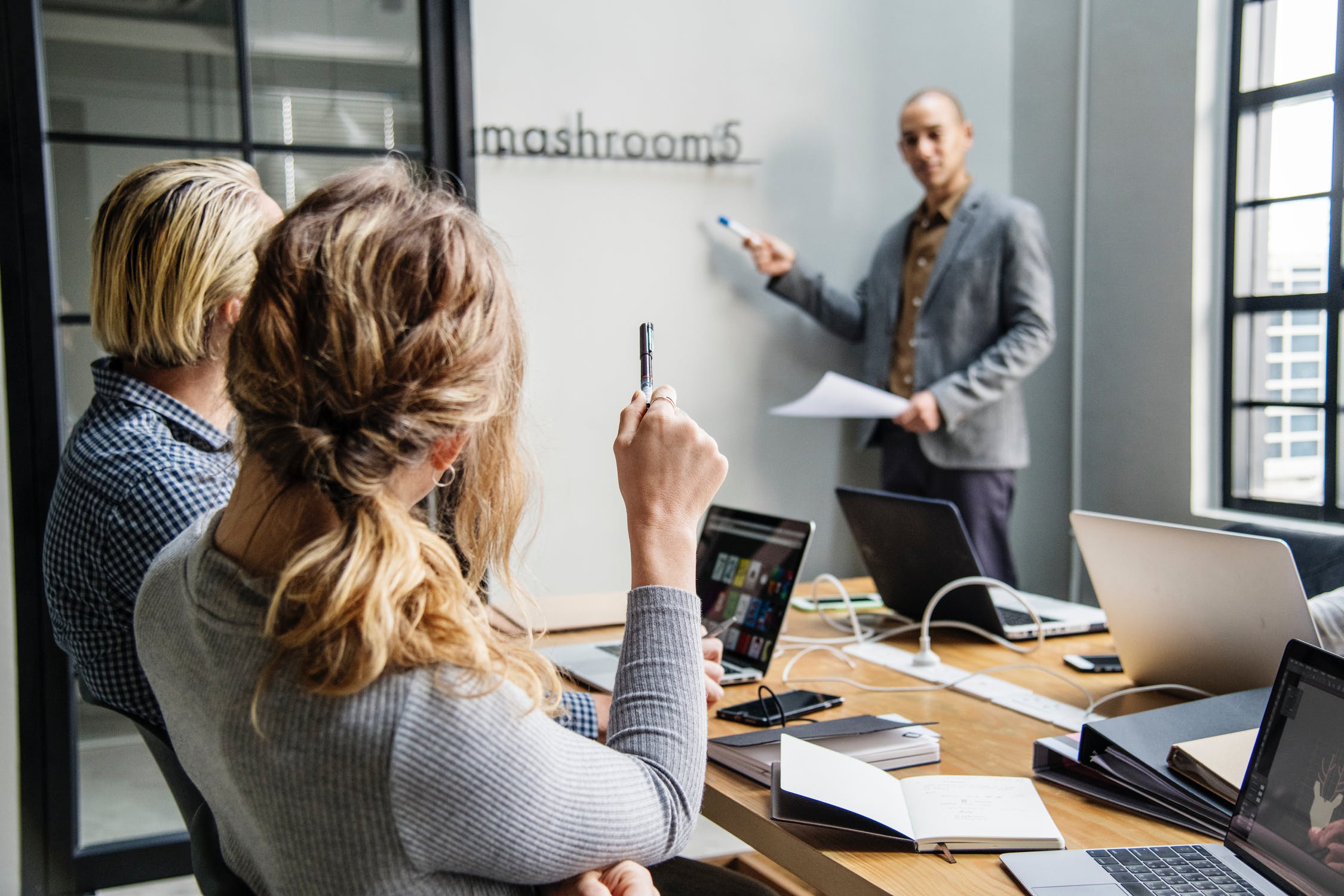 Business men and women in a room discussing B2B sales